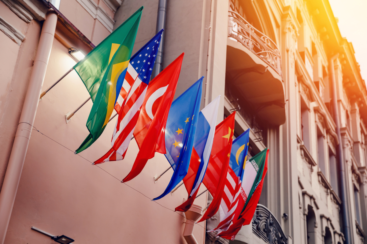 This is a photo of a building with country flags displayed in a row along one wall.