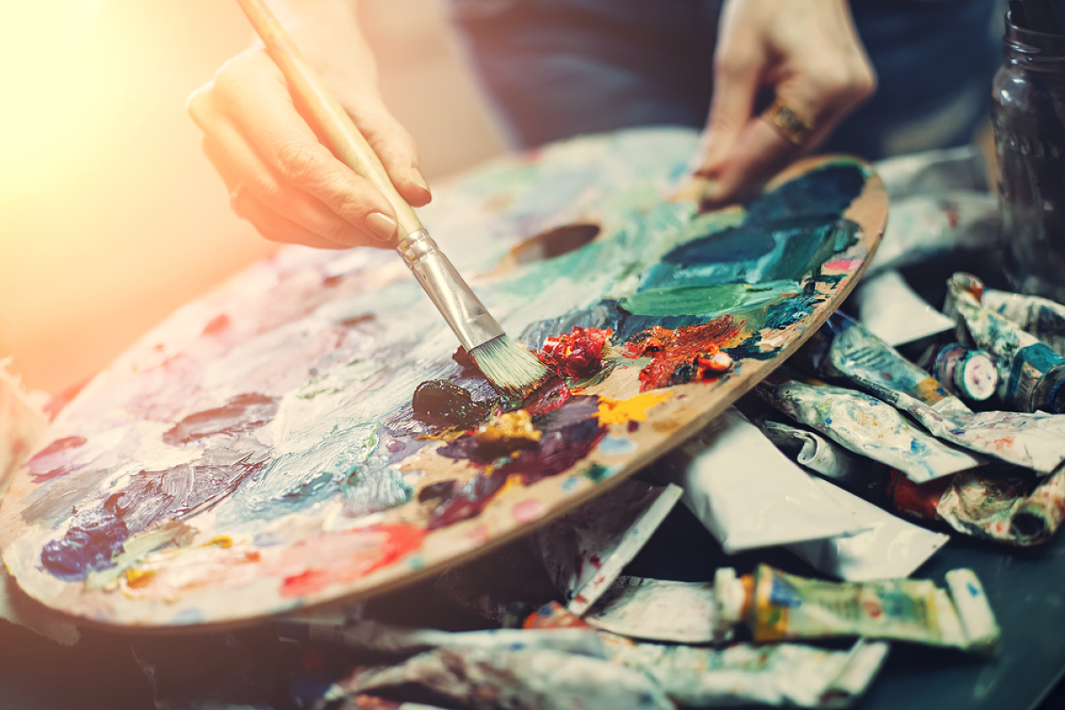 An artist's palette with a variety of paint colours.
