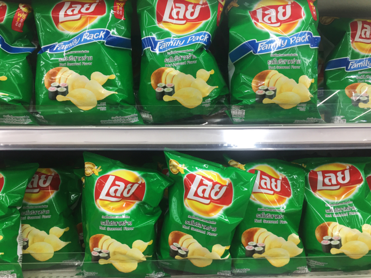 This is a green-coloured package of baked potato chips with an image of sushi on it.