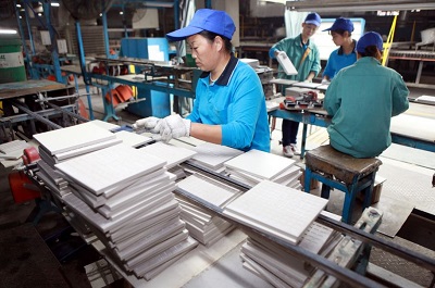 Employees in a Chinese factory work on the production of ceramic tiles.