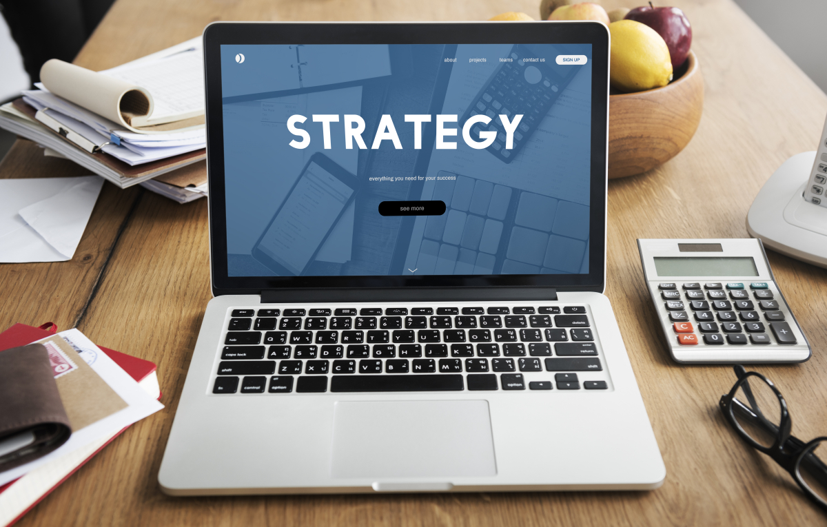 This is an image of a laptop with the word Strategy on the screen.