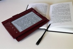 This is a photograph of a book and an ereader.