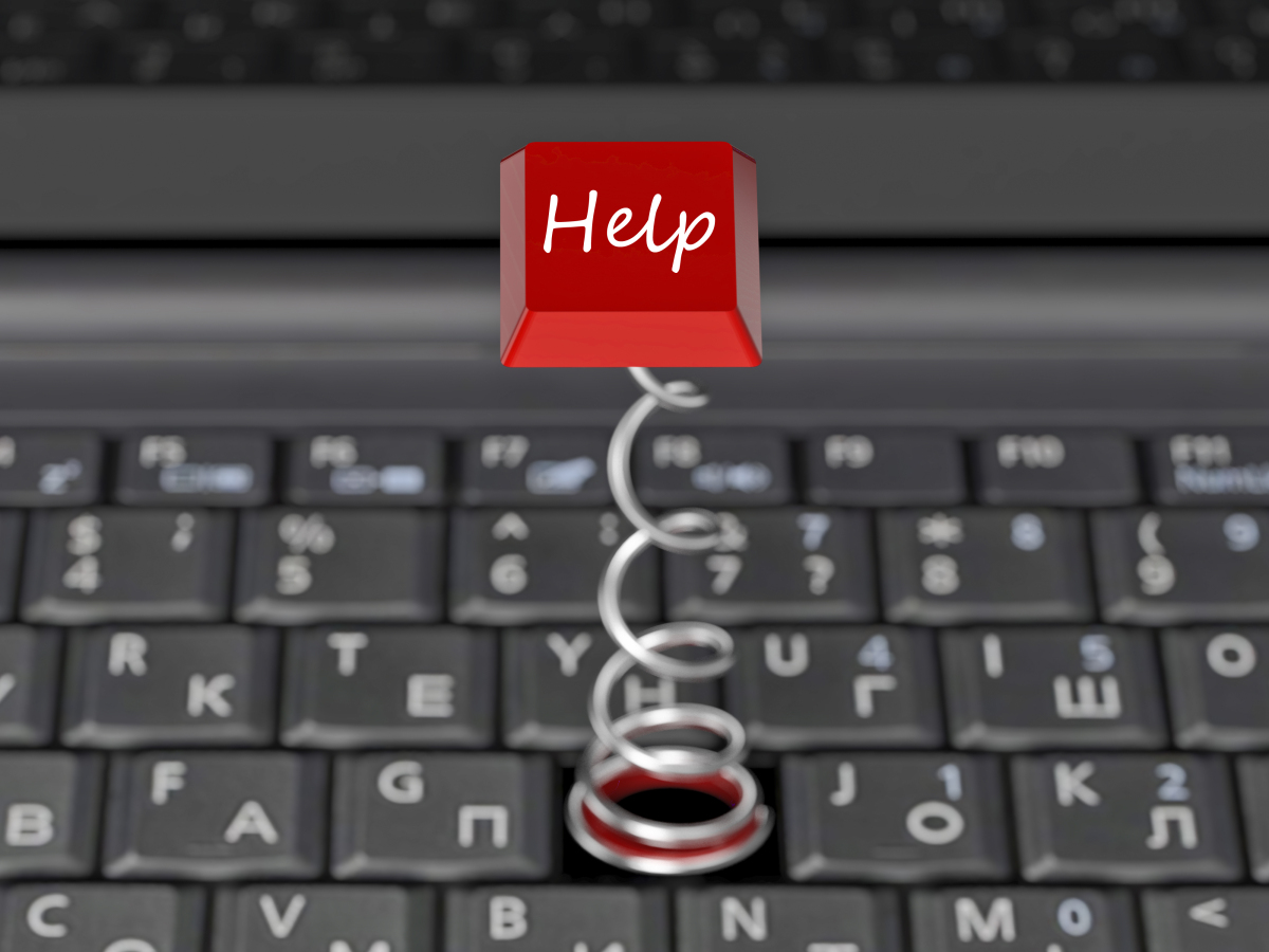 This is a photograph of a red help button popping off a computer keyboard.