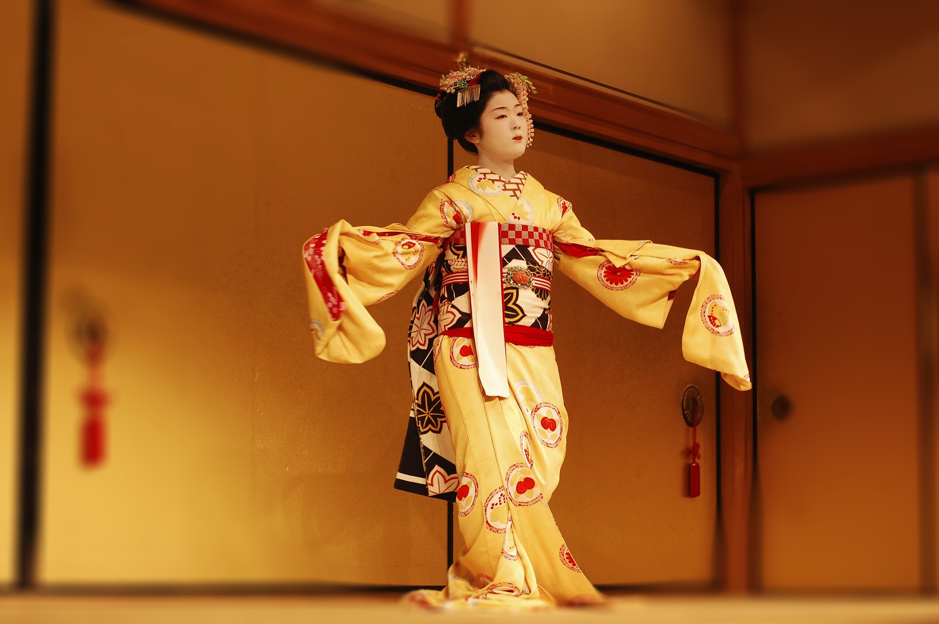 This is a photograph of a performer at a kabuki theatre in a kimono.  