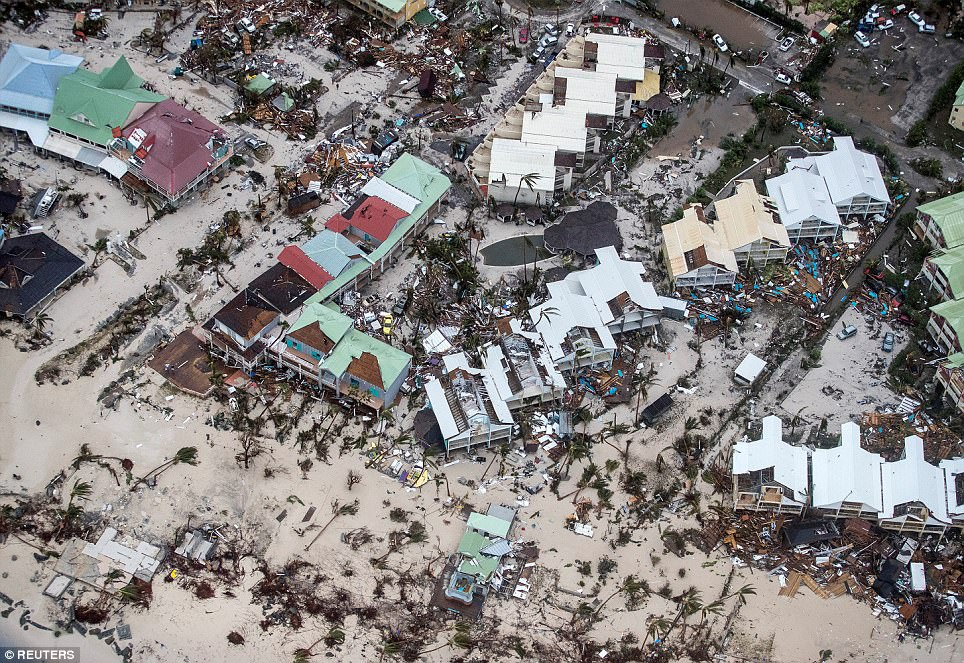 This is an aerial photograph of a resort in Barbuda. All of the palm trees have been uprooted and the roof has been torn off several buildings.