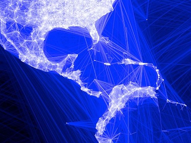 An illustration created by drawing lines between the locations of 10 million pairs of Facebook friends.  The background is blue and the lines between the pairs are white.  The greater the density of pairs, the more white appears.  The whitest parts of the illustration show the eastern United States and Europe.  India and south Asia are slightly less bright.  Africa and northern Asia are the darkest.