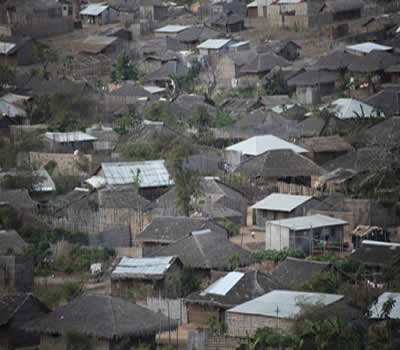 This is a picture of a village in Mozambique. There are simple, small, 1 to 2 room houses.
