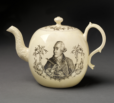 This is a photograph of a white, fine china teapot with a black line drawing of the 18th century London mayor, John Wilkes on it. He is framed by trees and greenery and there is additional decoration on the handle and lid.