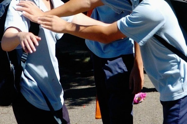 This is an image of three people. Two of the people seem to be pushing the third.