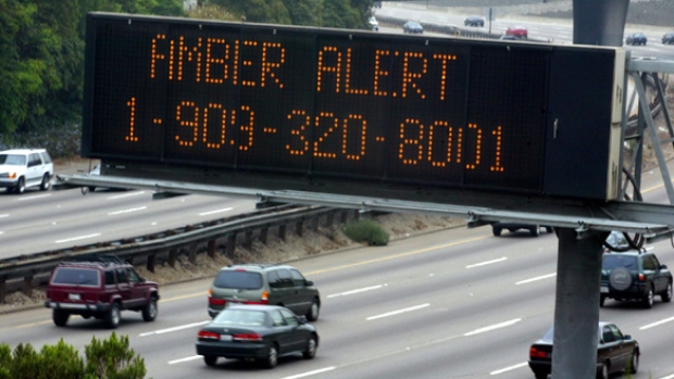 Cars pass a sign, indicating an Amber alert in effect for missing California girl, on the 101 freeway in Los Angeles in 2002.