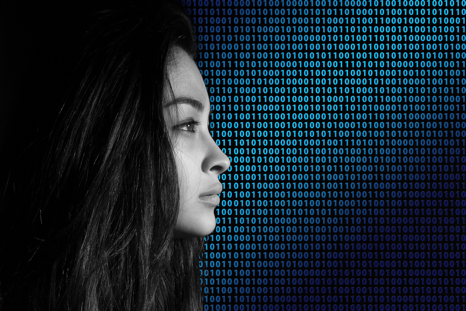 This is an image of a profile of a woman's face juxtaposed with 1s and 0s in the background.