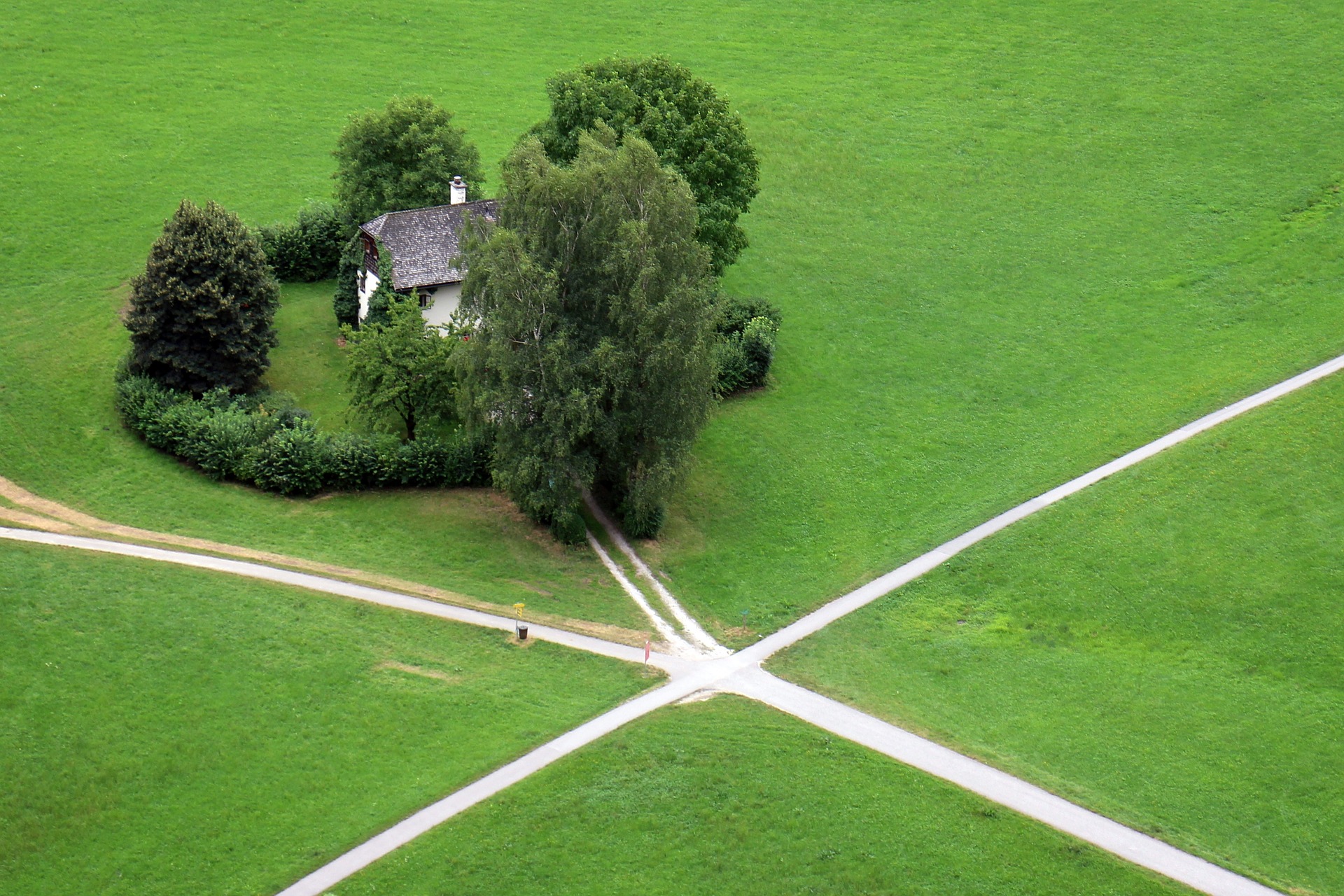 This is an aerial shot of a house surrounded by several paths, all of which lead to it.