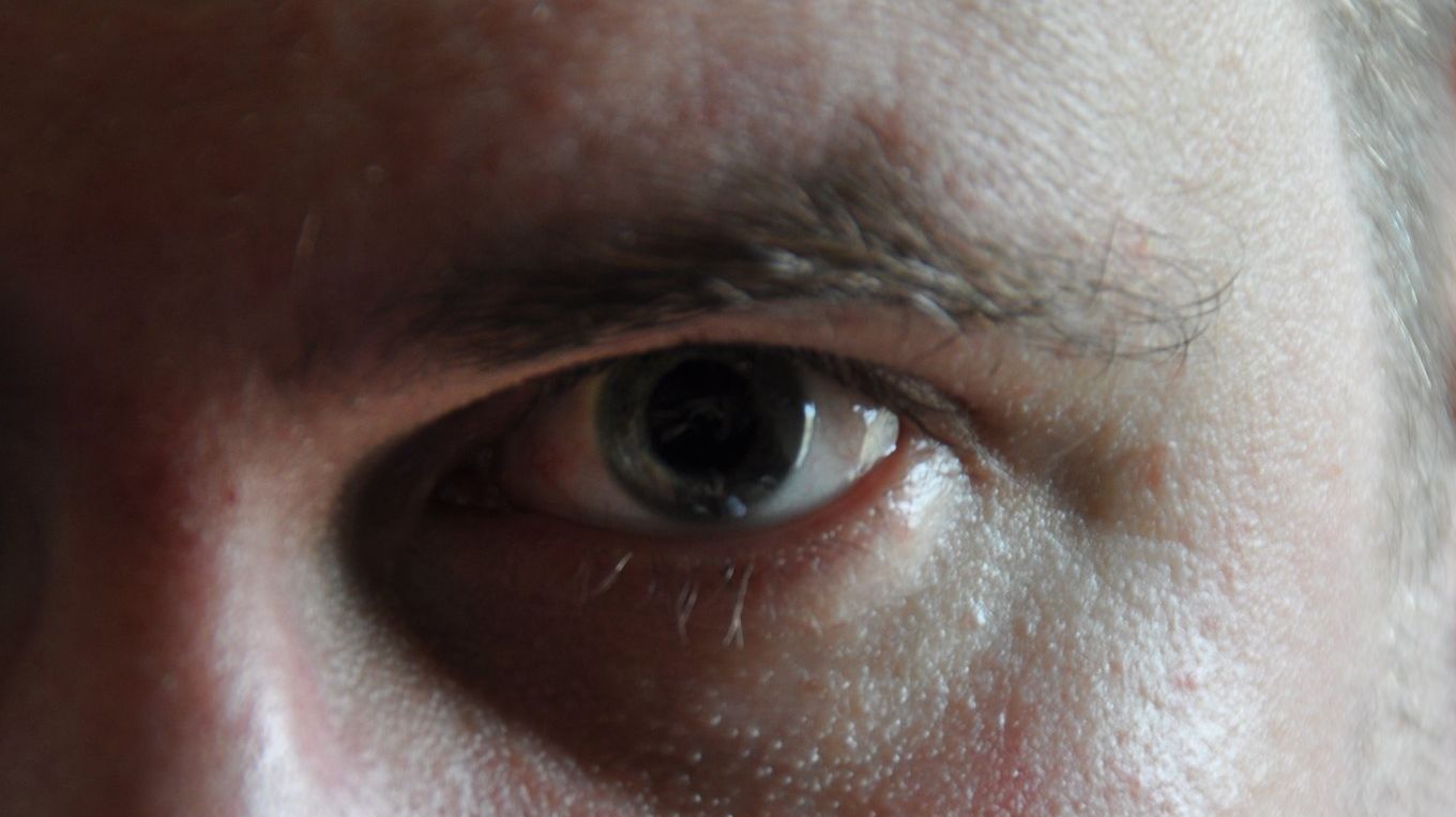 This is an image of an extreme close up of one green coloured eye.