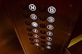 This is an image of elevator buttons which are all lit up.