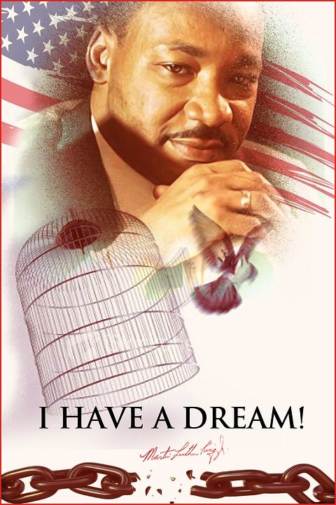This is an image of a poster with a drawing of Martin Luther King, Jr. with the American flag behind him, a bird flying out of a cage, broken chains, and the words &lsquo;I Have A Dream!
