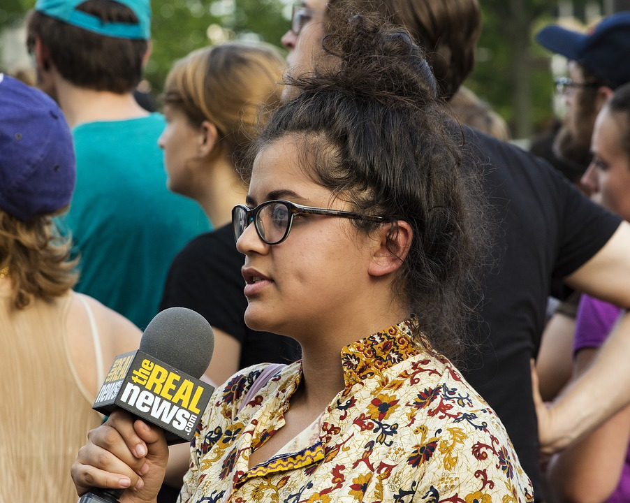 This is an image of a female reporter asking a question.