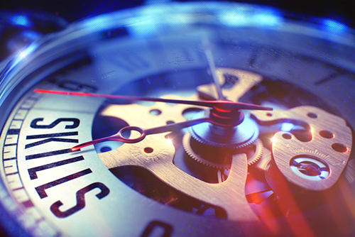 This is an image of a timepiece with an hour hand pointing to the word skills.