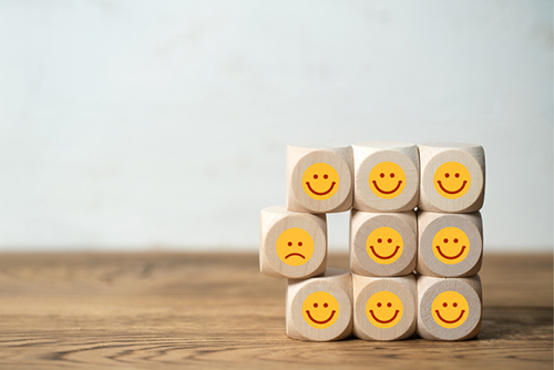 This is an image of a series of emojis drawn on wooden cubes.
