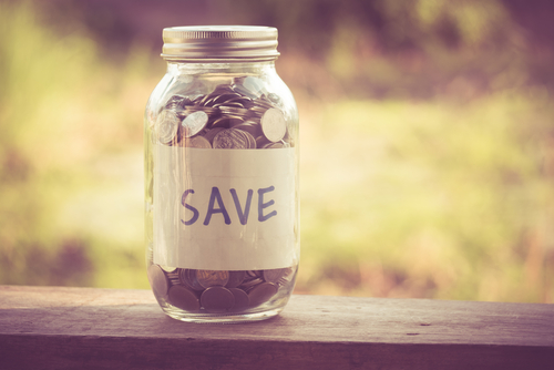 This is an image of a jar of money with the word Save on it.
