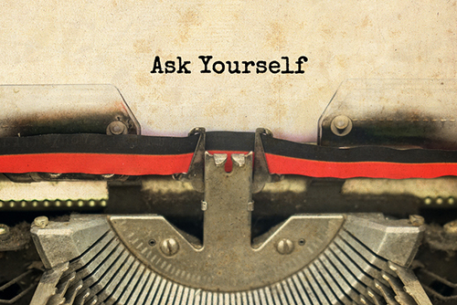This is an image of a typewriter with the words Ask Yourself typed on the page.