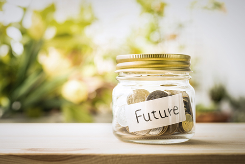 This is an image of a jar of money with the label on it that reads The Future.