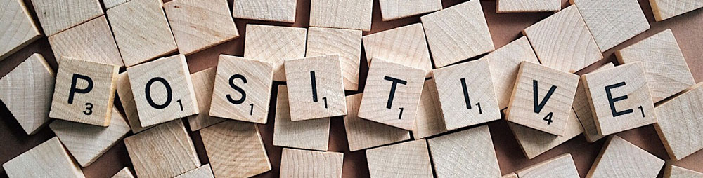 The word positive is spelled in Scrabble letters.