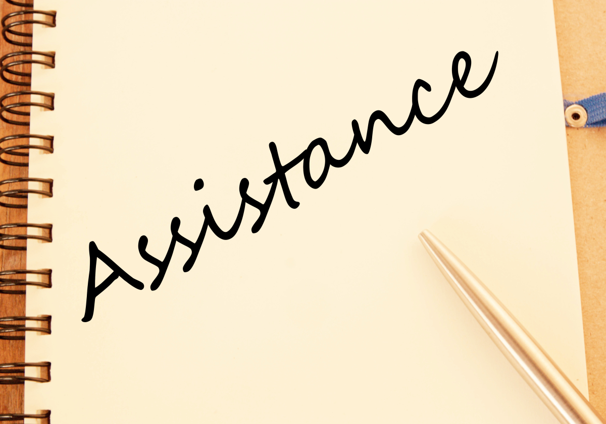This graphic shows the word assistance written on a notebook.