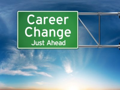 This is an image of an overhead highway sign, set against a blue sky background. The sign reads, &ldquo;Career Change Just Ahead.&rdquo;