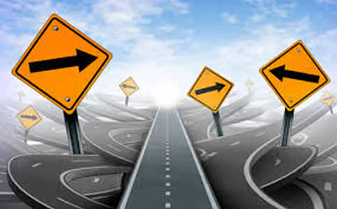 This a cartoon-like image of a straight highway disappearing in the distance into a blue horizon. Underneath it, however, is a convoluted web of overpasses and underpasses, as well as yellow yield signs, each containing an arrow pointing to the left or right.