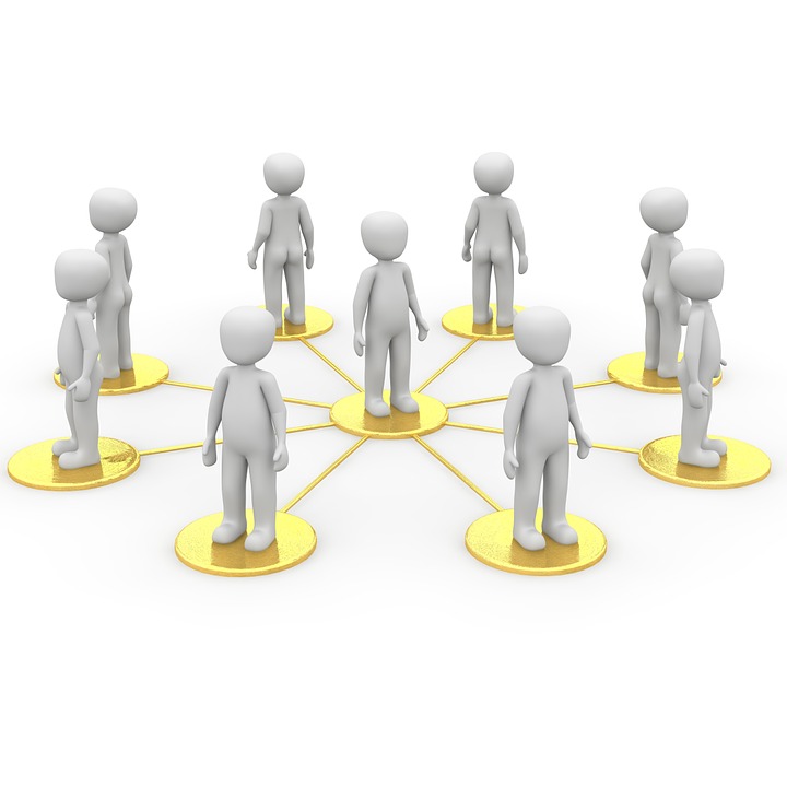 This is an image of several people, each represented by a 3D cartoon figure. One of the figures is standing in the middle of the white image on top of a gold circle. Encircling the figure are the eight other figures, each looking outward and standing on their own gold circle. The gold circle in the middle is connected to each of the surrounding gold circles with gold lines, representing a connection between the figure in the middle and the surrounding figures.