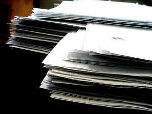 This is a close up image of a pile of resumes, interwoven, one on top of the other. They all look the same.