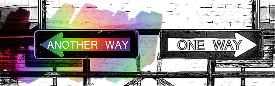 This is an image of a graphic sketch of two directional road signs pointing in opposite directions. One reads, ‘ONE WAY’ while the other reads, ‘ANOTHER WAY.’ The ‘ONE WAY’ sign is in black and white while the ‘ANOTHER WAY’ sign has a swath of various colours painted over top.