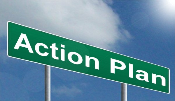 This is an image of a green highway sign set against a blue sky background. The sign reads in white lettering, ‘Action Plan.’