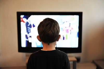 This is a photograph of a child watching television.