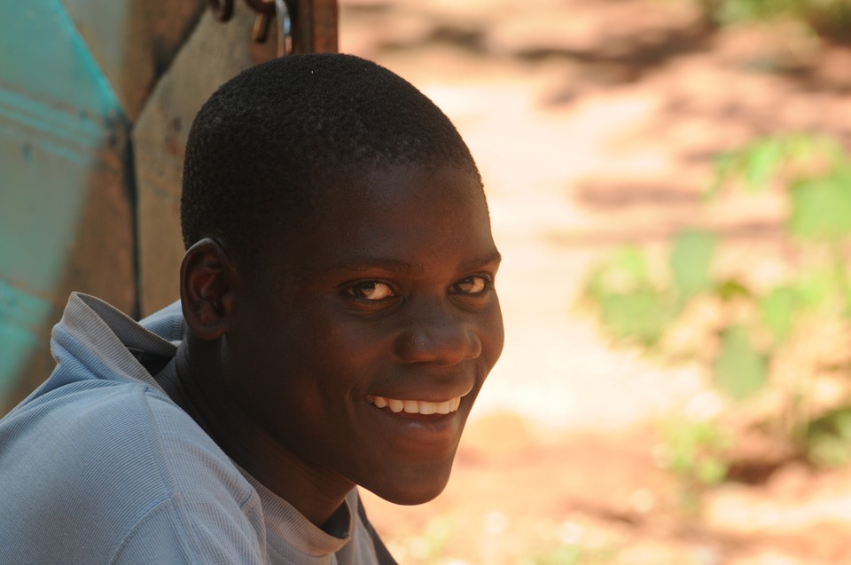 This is a photograph of a young African male. He is smiling.