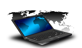 This is an image of a world map in the background and an open laptop in the foreground.