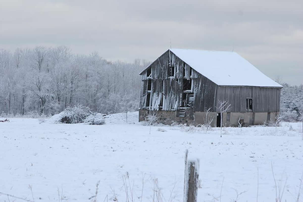 This is an image of an old barn in winter.