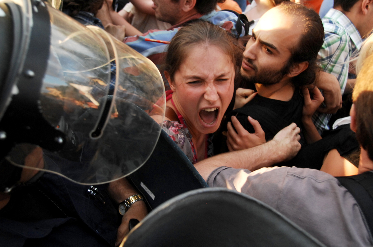 This young girl is screaming in front of a police riot, during the ecological protest against construction work at the Bulgarian sea coast.