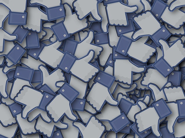 This image is of a pile of blue thumbs up like buttons from Facebook.