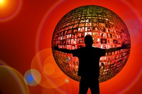 This globe is made up of a mosaic of human faces.