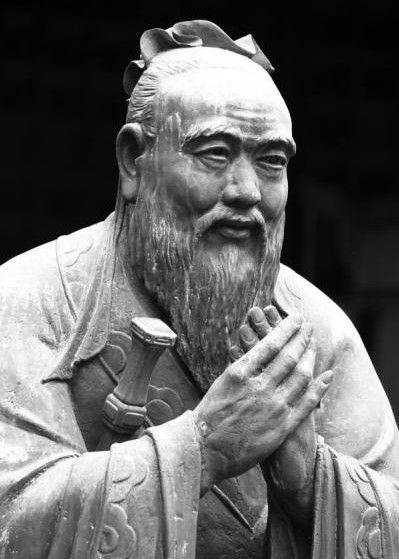 This is an image of an ancient statue of Confucius, a Chinese philosopher and educator.