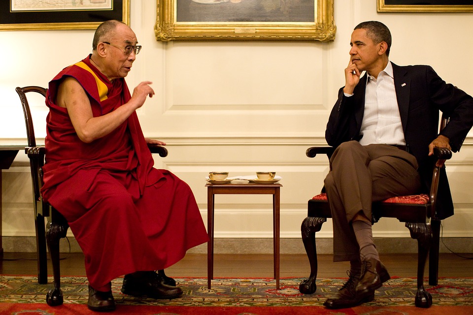 This is an image of the Dalai Lama engaged in a discussion with Barack Obama.