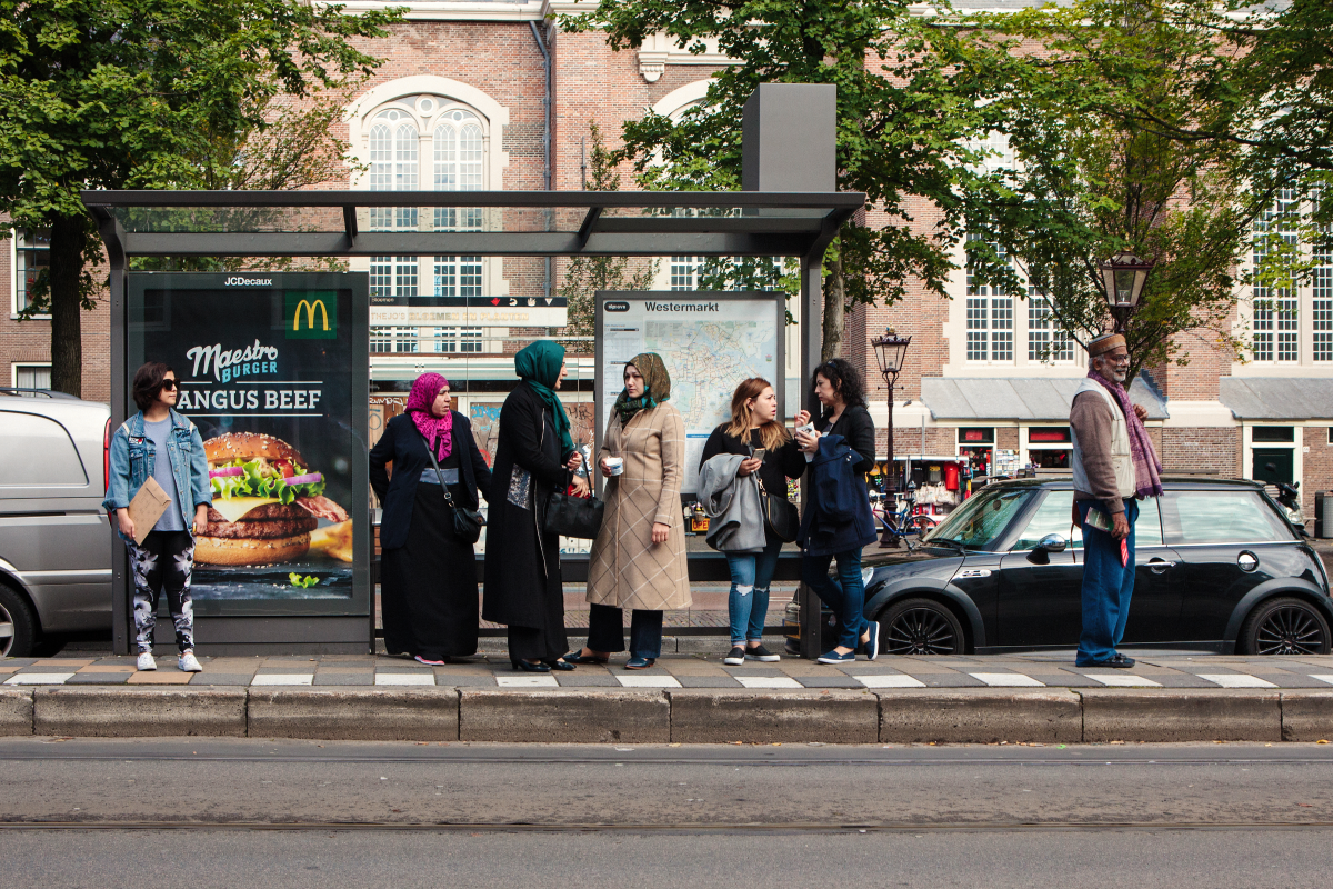 This is an image of people at a bus stop.