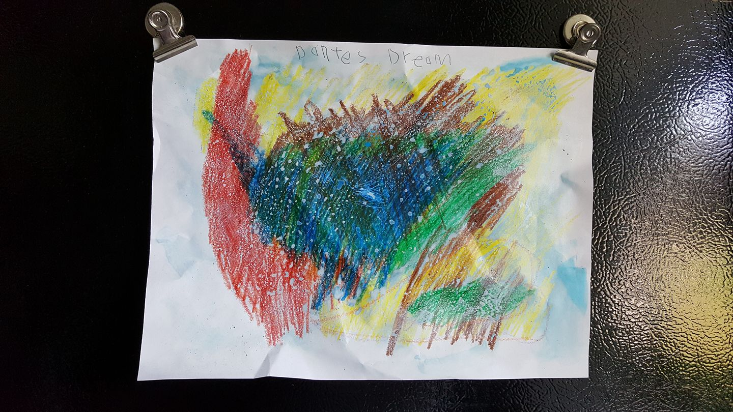 This is an image of a child’s drawing, stuck on a fridge with magnets.