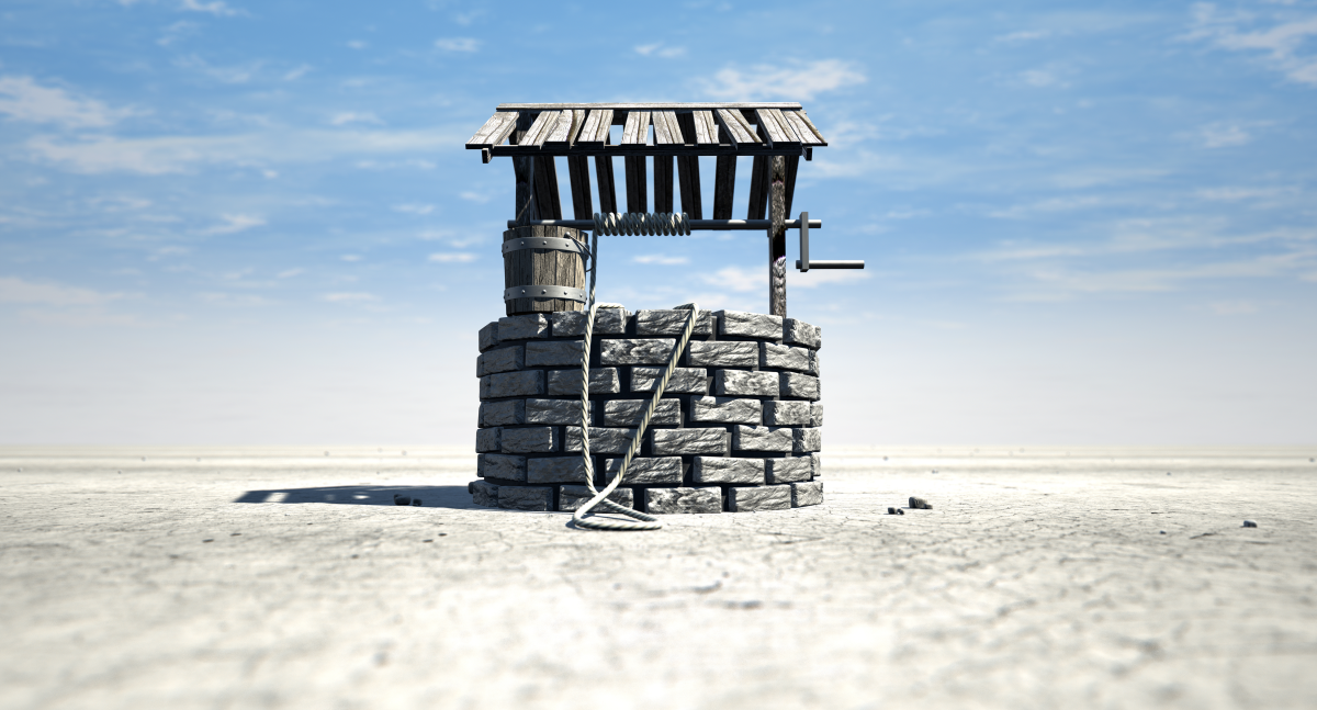 This is an image of a brick water well with a wooden roof and bucket attached to a rope in a flat barren landscape with a blue sky background.