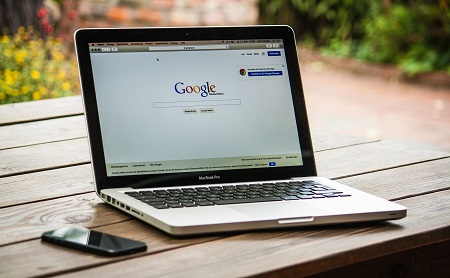 An image of a laptop showing the google search engine.