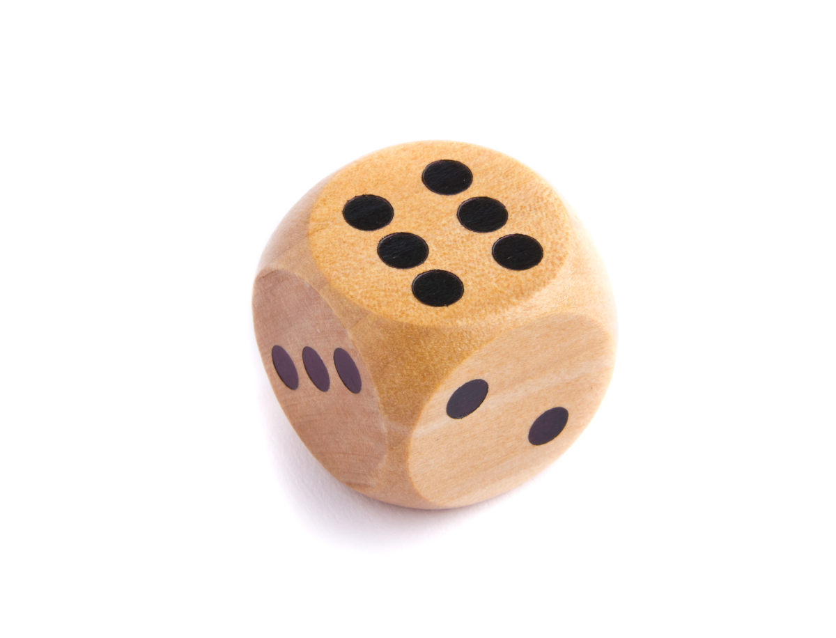 This is an image of a wooden die showing 6 dots.