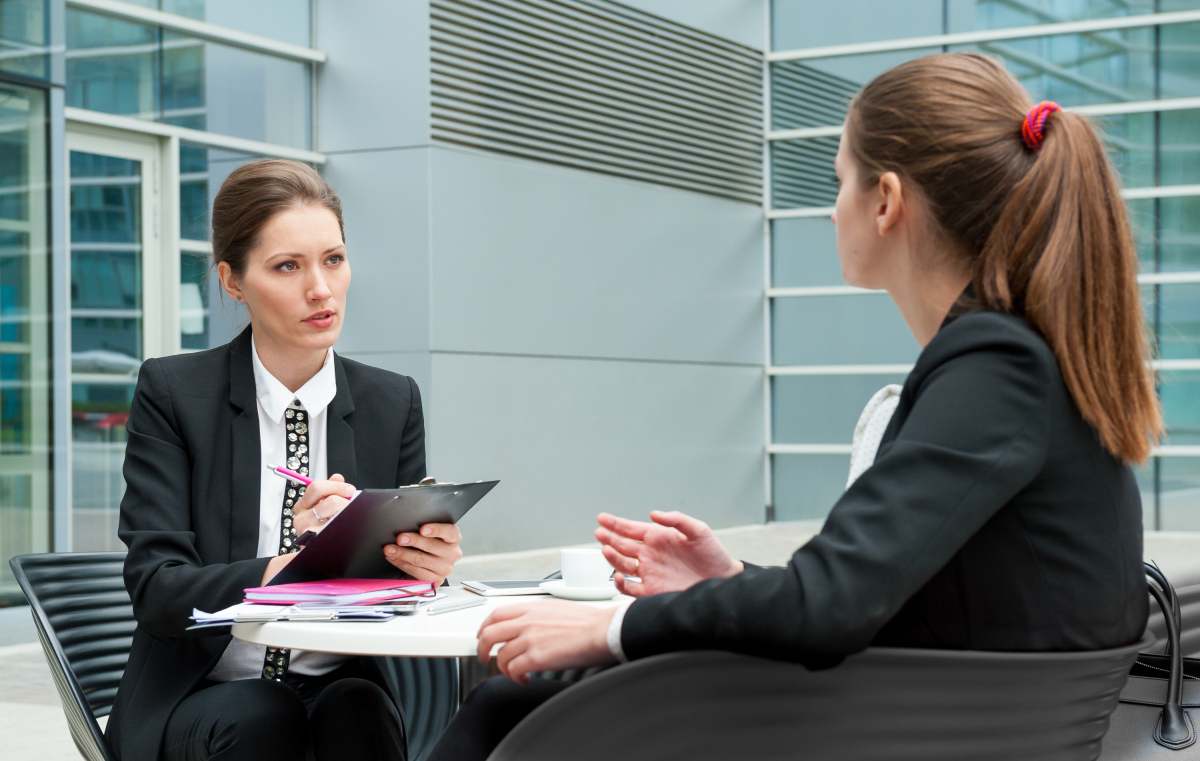 This is an image of a woman surveying another woman.