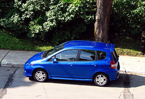 This is a photograph of a newer model car sitting in a driveway.