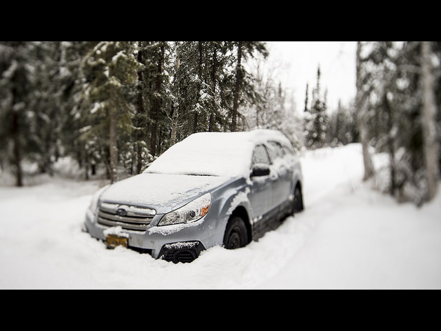 This is an image of a car driving in the snow.